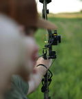 Person aiming with a bow using Sync Drop Away Archery Arrow Rest With Smooth Cable Driven Draw For Consistent Shot Laterally Adjustable Launcher Arms Easy Windage And Elevation Adjustments Right Hand Black Today