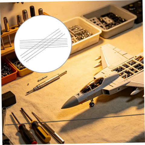 Workbench with model aircraft, surrounded by tools and 10 Pcs Carbon Fiber Rods 2mm Diameter And 500mm Length For RC Planes and Drones.