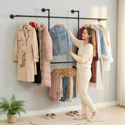 Heavy Duty Industrial Pipe Clothing Rack With Four Hanging Rods Wall Mounted Garment Rack Black Steel Frame with coats and denim.