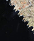 Close-up of serrated edge on Beefy Mini Wrecker Stump Bucket for Small Tractors Heavy Duty Tractor Attachment for yard clearing.