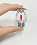 Heavy Duty Upright Fire Sprinkler Head With 68 Celsius Red Glass Bulb And Durable Copper Alloy Frame Finished In Polished Chrome held in hand.