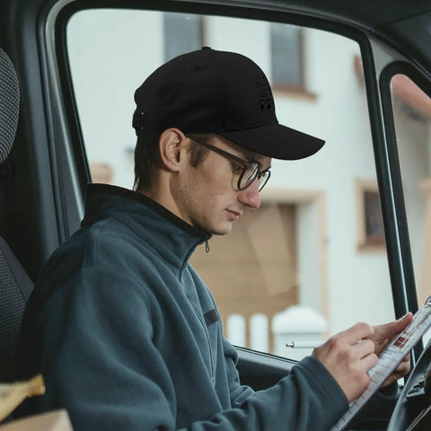 Man wearing Lightweight Adjustable Cotton Dad Hat for Men with Relaxed Fit, sitting in vehicle reading paper