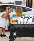 Woman and child with 165L Collapsible Folding Wagon With Silent All Terrain Wheels Heavy Duty Utility Cart loaded with groceries
