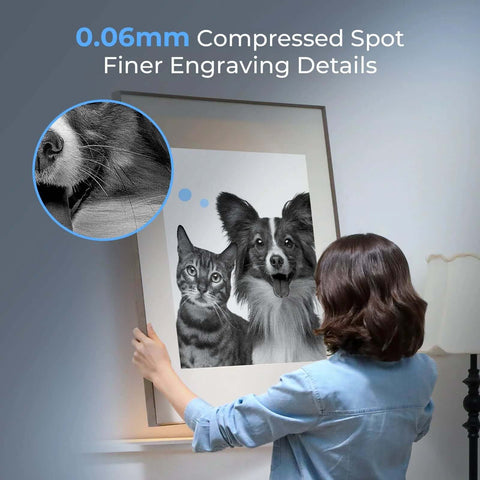 Front view of Creality laser engraver; person hangs large grayscale dog-and-cat print with fur detail inset