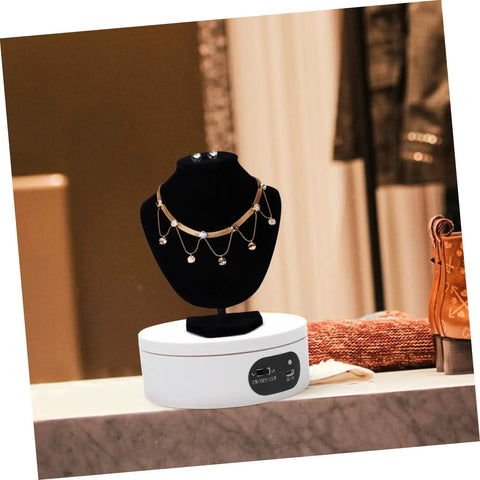 Rotatable Jewelry Display Stand With Electric Motorized Turntable Skid Base showcasing a gold necklace on a black bust.