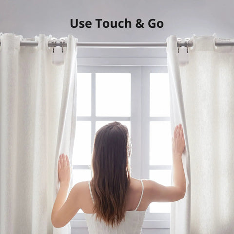 Woman adjusting curtains with Smart Curtain Motor With Wireless App Control And Timers Works With Alexa Google Home And IFTTT Hub Ready For Smart Home Setup Rod20 Version White Easy No Tool Installation For Smooth Sliding.