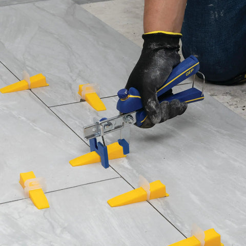 Using Tile Leveling Pliers Kit For Lash And Xtreme Pro Systems with adjustable head and wedges on floor tiles.