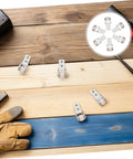 Six Pack Nylon Guide Wheels In Clean White For Furniture Track Systems And Drawer Hardware on wooden surface.