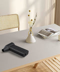 Professional Cordless Air Blower With 180 Watt Brushless Motor Delivering 130000 RPM on a table, ideal for dust cleanup and pet drying.