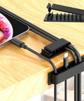 Cable holders and clips from 192 Pcs Cable Management Kit With 4 Wire Organizer Sleeves, installed under a wooden desk.