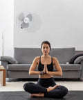 16 Inch Remote Control Oscillating Fan With Quiet 3 Speed Settings in living room with person meditating