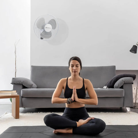 16 Inch Remote Control Oscillating Fan With Quiet 3 Speed Settings in living room with person meditating