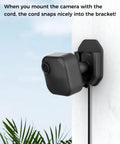 Three Pack No Drill No Screws Adhesive Wall Mount Brackets with Blink camera mounted and cord in bracket outdoors.