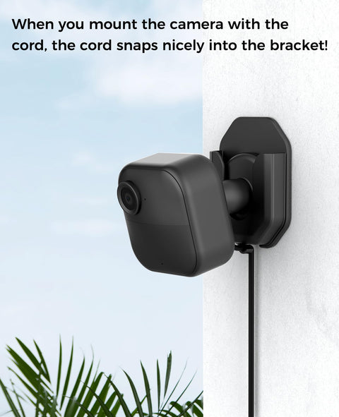 Three Pack No Drill No Screws Adhesive Wall Mount Brackets with Blink camera mounted and cord in bracket outdoors.