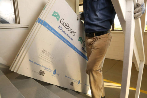 No Sweat Ultralight Shower Wall Panel Kit Three Foot X Five Foot Half Inch Boards being carried upstairs for installation.