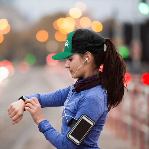 Woman running outdoors wearing a Breathable Low Profile Trucker Cap For Men With Adjustable Buckle Dope Modern Baseball Hat in green