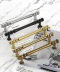 10 Pack 3 Inch Antique Brass Cabinet Pulls, Vintage Zinc Alloy Handles displayed with color variations on marble surface