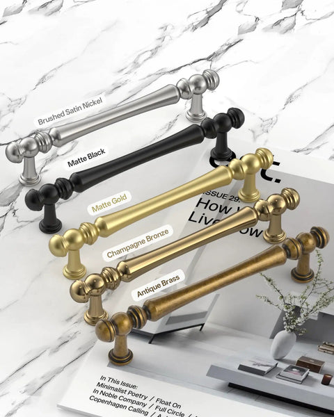 10 Pack 3 Inch Antique Brass Cabinet Pulls, Vintage Zinc Alloy Handles displayed with color variations on marble surface
