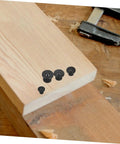 Eight Piece Dowel Transfer Pin Kit with marker center points on wooden board for accurate dowel alignment in woodworking and carpentry
