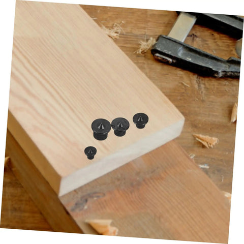 Eight Piece Dowel Transfer Pin Kit with marker center points on wooden board for accurate dowel alignment in woodworking and carpentry