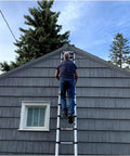Man climbing Telescoping Ladder 15.5 Ft Reach 250 Lb Capacity With True Telescoping Tech Safety Closure And Individual Rung Locks No Pinch Close Foot Trigger Extension A Real Workhorse For Home Projects And Pro Jobs on gray house