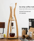 Adjustable Detachable Glass Cold Brew Drip Tower For Crafting Legit Smooth Iced Coffee And Refreshing Loose Leaf Tea With Reusable Fine Mesh Filter To Skip The Bitter Aftertaste displayed with wooden base and glass components.