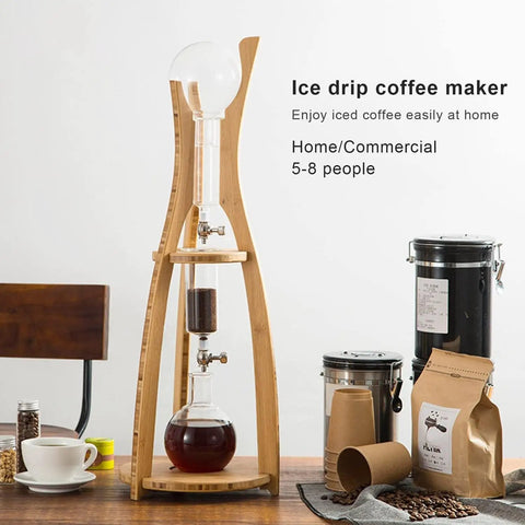 Adjustable Detachable Glass Cold Brew Drip Tower For Crafting Legit Smooth Iced Coffee And Refreshing Loose Leaf Tea With Reusable Fine Mesh Filter To Skip The Bitter Aftertaste displayed with wooden base and glass components.