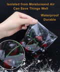 Hand holding Clear Resealable 5x7 Inch Cellophane Bags 300 Pack For Bakery Candles Soap Cookies with cherries inside.