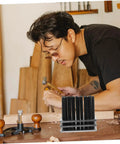 Machinist using the Beefy Pro Grade Transfer Punch Set for precise hole marking and alignment on a wooden block.
