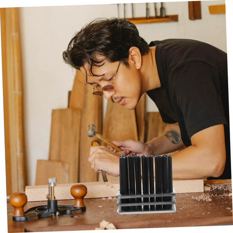 Machinist using the Beefy Pro Grade Transfer Punch Set for precise hole marking and alignment on a wooden block.