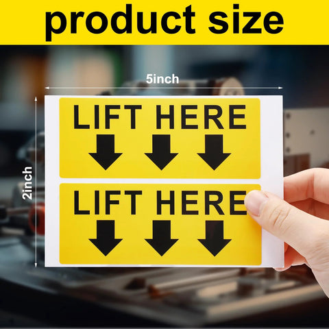 Two bright yellow lift here label decals, 5x2 in, black text with downward arrows.