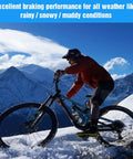 Cyclist riding mountain bike in snow with 25 Pairs Copper Semi-Metallic Mountain Bike Disc Brake Pads For Hydraulic Brakes.