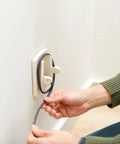 Outlet Cover With Cord Shortener For Baby Proofing Provides Full Outlet Coverage Keeps Excess Cords Off The Floor Stores Up To Four Feet Of Cords Kid Safe And Easy To Remove Totally Great For Curious Little Ones in use being installed