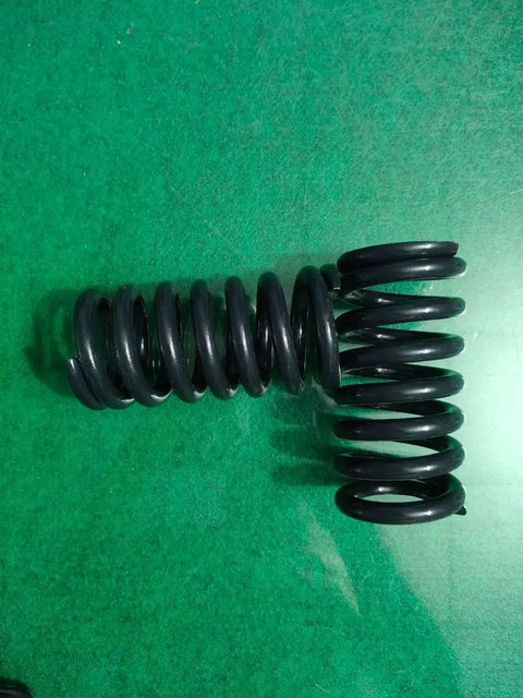Built Different Heavy Duty Compression Springs Set Of Two High Carbon Steel Industrial Gear on green background.