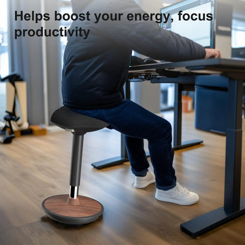 Person using Active Sitting Wobble Stool for Standing Desk, Anti Fatigue Stool, walnut finish, in home office setting.