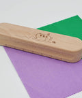 Wooden Clapper Tool For Pro Sewing And Quilting Nine Point Five Inch Hardwood Ironing Clapper on colored fabric