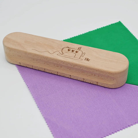 Wooden Clapper Tool For Pro Sewing And Quilting Nine Point Five Inch Hardwood Ironing Clapper on colored fabric