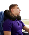 Man on bus using Rose Memory Foam Travel Neck Pillow U Shape With Zippered Cover For Planes Trains Cars And Office Naps