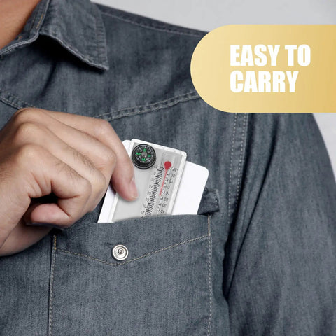 Two Pack Portable Keychain Compass With Thermometer Wear Resistant Mini Pocket Navigator being put into a denim shirt pocket