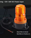 Amber LED strobe beacon on black base with red positive and black ground power wires