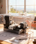 AcmeFlare 60W Mini Metal Lathe Machine in transparent box on a workbench, showcasing all metal construction for model making and crafts.