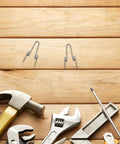 Ditch Your Wonky Flip Lid With These Rock Solid Stainless Steel Torsion Springs And Make DIY Repairs A Breeze For Any Trash Can In the Kitchen Or Home, two springs on wood