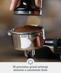 Close-up of coffee being tamped in a portafilter for Barista Express Inspired Espresso Machine With Built In Grinder For Quick Beans To Espresso Dose Control Grinding 4 Keys Formula Home Barista Setup In Brushed Stainless Steel.