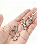 Hella Durable Zinc Alloy Swivel Snap Hooks And D Rings For Purse Hardware, Keychain Crafting, Sewing, 122 Piece Kit With Smooth Turn Clasps, Half Inch Opening, Total Breeze To Use displayed in hand.
