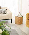 Woven Rope Storage Basket With Handles For Blankets, Toys, Clothes And Plants, Natural Jute Organizer Bin in a living room setting.