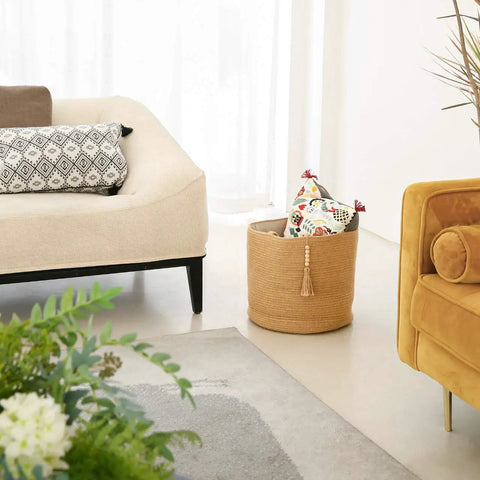 Woven Rope Storage Basket With Handles For Blankets, Toys, Clothes And Plants, Natural Jute Organizer Bin in a living room setting.