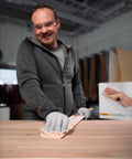 Man using Soft Hand Sanding Sheets 4.5 By 5 Inch Grit 240 On Perforated Roll 200 Sheets A Weight Latex Backing in workshop