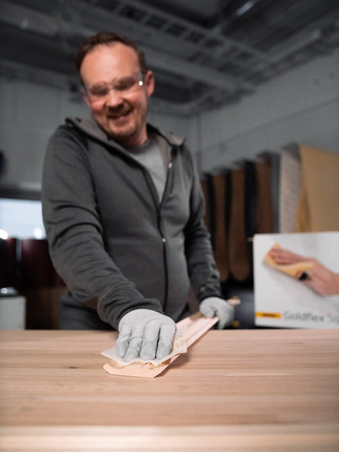 Man using Soft Hand Sanding Sheets 4.5 By 5 Inch Grit 240 On Perforated Roll 200 Sheets A Weight Latex Backing in workshop