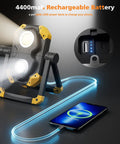 2 Pack 2500LM Magnetic Rechargeable Work Light With 360 Degree Rotating Stand And Foldable Design, shown charging a phone