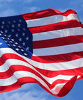 The American flag waving against a clear blue sky